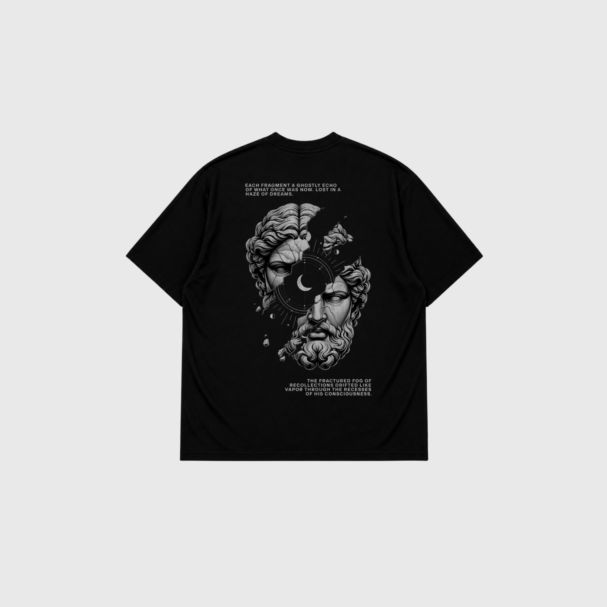 Black oversized T-shirt displayed from the back on a light gray background. Large monochrome graphic of a classical marble statue face split by abstract elements and a crescent moon, with decorative text above and below the artwork.